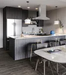 Contemporary kitchen with elegant dark wood finishes, modern pendant lighting, and a sleek marble dining table.