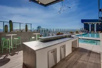 Breathtaking rooftop terrace with panoramic city views, featuring modern outdoor seating and a luxurious swimming pool.