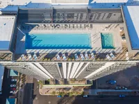 Breathtaking aerial view of a modern rooftop pool and lounge area, offering luxurious relaxation and stunning cityscape vistas.