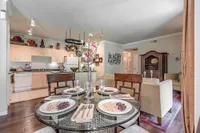 Charming open-plan kitchen and dining area featuring elegant table setting and cozy living room.