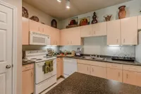 Charming kitchen with modern appliances, ample cabinet space, and elegant decor for a cozy culinary experience.