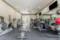 Wellness Starts Here Modern fitness center featuring state-of-the-art gym equipment, mirrored walls, and bright natural lighting.