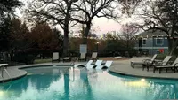 Serene Spaces, Stunning Views Tranquil poolside scene with elegant loungers and twinkling string lights, perfect for relaxation in a serene outdoor setting.