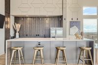 Sip, Chat, Repeat Modern kitchen with sleek bar design, featuring four elegant wooden stools, stylish pendant lighting, and a backdrop of sophisticated wooden paneling.