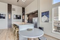 Where Style Meets Function Sophisticated modern kitchen with sleek countertops, stylish pendant lighting, and chic bar stools, perfect for entertaining.