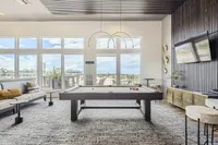 Sleek Spaces for Big Fun Spacious and elegant game room with a billiards table, modern seating, and large windows offering stunning views.