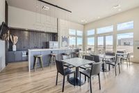 Stylish Spaces to Lounge & Connect Modern communal kitchen and dining area with ample natural light, sleek countertops, and stylish seating.