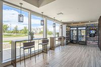 Cafe-style comfort Modern snack bar with large windows, sleek seating, and stocked vending area, offering a bright and inviting atmosphere.