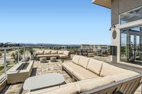 Fireside Chats Start Here Exceptional rooftop terrace showcasing luxurious outdoor seating with breathtaking city views and modern amenities.