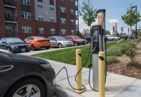 Power up, drive on Modern apartment building with convenient EV charging station in the parking area, surrounded by well-kept landscaping.