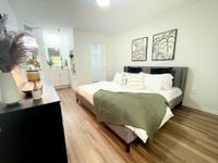 Peaceful, Private, Perfect Bright and inviting bedroom with chic decor, featuring a cozy bed, stylish artwork, and a modern vanity in a spacious layout.