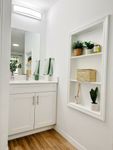 Modern Bathrooms, Timeless Design Chic bathroom with a modern vanity, elegant shelves, and inviting greenery, perfect for a serene and stylish home.