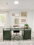 Get Things Done—Right at Home Elegant home office with a sleek glass desk, stylish brown chair, and artistic wall gallery, offering a serene workspace atmosphere.