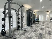 Strong Living Starts Here Modern fitness center featuring state-of-the-art weight machines and vibrant workout equipment in a well-lit, spacious room.