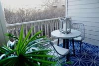Your Private Outdoor Escape Charming balcony with cozy seating, stylish lantern decor, and vibrant greenery for a refreshing outdoor retreat.