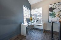 Workspaces That Inspires Bright and modern home office with a sleek desk, comfortable chair, and large windows offering ample natural light.