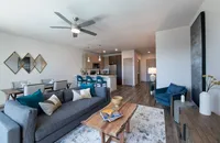 Modern open-concept living space with elegant dining area, stylish kitchen, and cozy seating with vibrant decor.