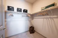 Spacious walk-in closet with sleek shelving, stylish storage bins, and plenty of hanging space.