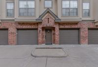 Stunning townhouse entrance with elegant brick facade and dual garages.