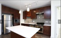 Cook, Dine, Entertain—Your Way Modern kitchen with sleek dark wood cabinetry, stainless steel appliances, and a bright central island creating an inviting space for culinary creativity.