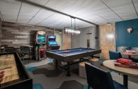 Game Room Goals, Achieved Chic game room featuring a pool table, arcade games, board games, and modern decor for ultimate entertainment.