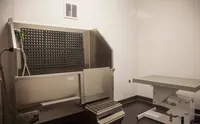 Clean Pets, Happy Homes Sleek and modern veterinary clinic room with advanced stainless steel equipment and a streamlined exam table.