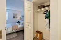 Functional Spaces That Flex with You Inviting bedroom with modern decor, cozy bed, and spacious closet, perfect for restful living.