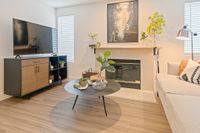 Where Every Detail Feels Like Home Chic living room featuring modern decor, sleek wooden floors, a cozy fireplace, and a stylish TV setup.