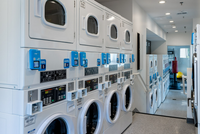 Laundry, Made Simple Modern apartment complex laundry room featuring state-of-the-art washers and dryers with digital controls, sleek design, and ample folding space.