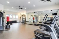 Wellness Starts Here Modern gym with state-of-the-art equipment, including treadmills, punching bags, and weight machines, in a spacious, well-lit environment.