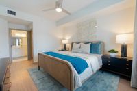 Peaceful, Private, Perfect Inviting bedroom with stylish decor, featuring a cozy wooden bed, elegant bedside lamp, and soothing blue accents.