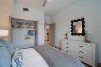 Sleep In, Stretch Out Elegant bedroom with cozy bed, modern decor, and spacious closet space, offering a serene retreat in a contemporary apartment.