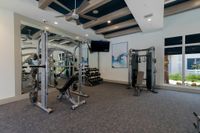 Fully Equipped for Every Workout Modern fitness center with state-of-the-art equipment, stylish decor, and large windows providing a bright and inviting atmosphere.