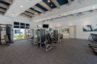 Strong Living Starts Here Modern fitness center with state-of-the-art gym equipment, natural lighting, and contemporary design.