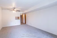 Inviting living space in The Hampton, featuring a ceiling fan, cozy carpeting, and seamless transition to the hallway, ideal for comfort in a 1 bed, 1 bath apartment, 630 sq ft.