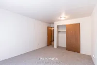 Inviting bedroom interior in The Hampton apartment, featuring cozy carpeting and a spacious closet, perfect for a one-bedroom retreat.