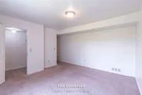 Inviting bedroom with soft carpet and natural light in The Somerset, featuring 2 beds, 1 bath, 970 sq ft.
