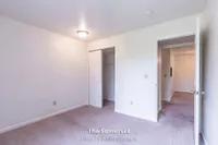 Bright bedroom space in The Somerset apartment featuring soft carpet flooring and ample closet storage, perfect for a cozy living experience in a 2 bed, 1 bath layout spanning 970 sq. ft.