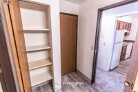 Charming apartment showcasing a spacious kitchen with modern appliances and ample storage space. Featuring The Wellington, a 2 bed, 1 bath layout in 900 sq. ft.