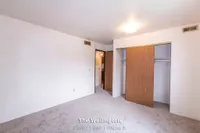 Bright and inviting bedroom at The Wellington with ample closet space, showcasing a modern design in a 2 bed, 1 bath layout, 900 sq. ft.