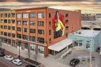 Chic urban apartment building with vibrant mural art, showcasing a modern blend of architecture and creativity, ideal for city living.
