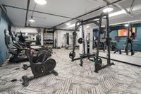 Modern gym equipped with state-of-the-art exercise machines, free weights, and a stylish interior design.