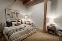 Inviting master bedroom featuring a cozy platform bed with plush pillows, elegant wooden beam accents, and soft ambient lighting.