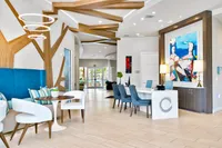 Chic and modern lobby featuring stylish blue seating, artistic decor, and unique wooden accents with elegant lighting.