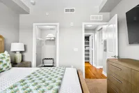 Inviting bedroom with stylish decor, spacious walk-in closet, and elegant details for a serene living experience.