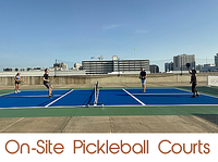 Vibrant on-site pickleball courts with players enjoying a match, set against a city skyline backdrop.