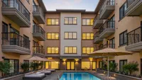 Pool and Spa at Sunset with Balconies and Cabana Beds