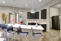 Modern kitchen design with sleek countertops, chic barstools, and stylish pendant lighting, creating a welcoming and elegant atmosphere.