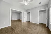 Bright and modern apartment interior featuring sleek hardwood floors, ample closet space, and natural light cascading through large windows.
