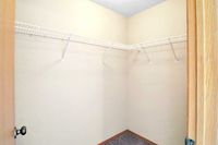 Spacious walk-in closet with ample shelving, perfect for organized storage and maximizing wardrobe space.